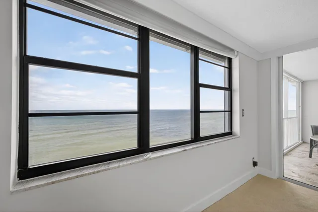 a bathroom with a granite countertop sink mirror and shower