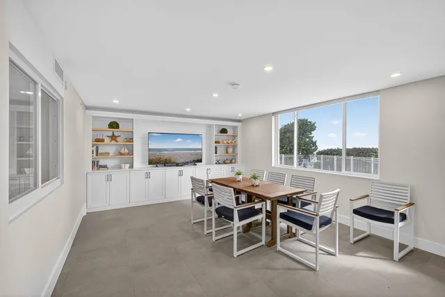 a view of a building with backyard and sitting area