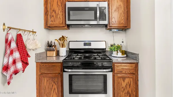 a stove top oven sitting inside of a kitchen