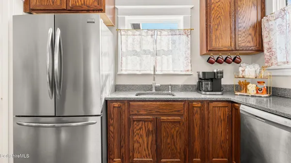 a kitchen with stainless steel appliances granite countertop a refrigerator and a sink