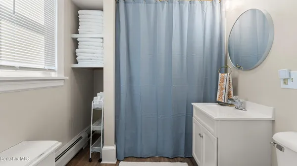 a bathroom with a sink a toilet and a mirror