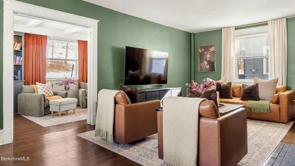 a living room with furniture and a flat screen tv