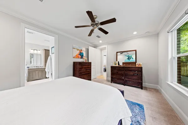 a bedroom with a bed dresser and a window