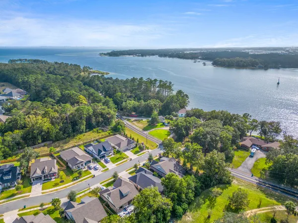 an aerial view of residential house with outdoor space and lake view