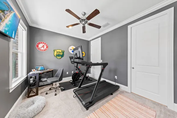 a work room with furniture and a ceiling fan