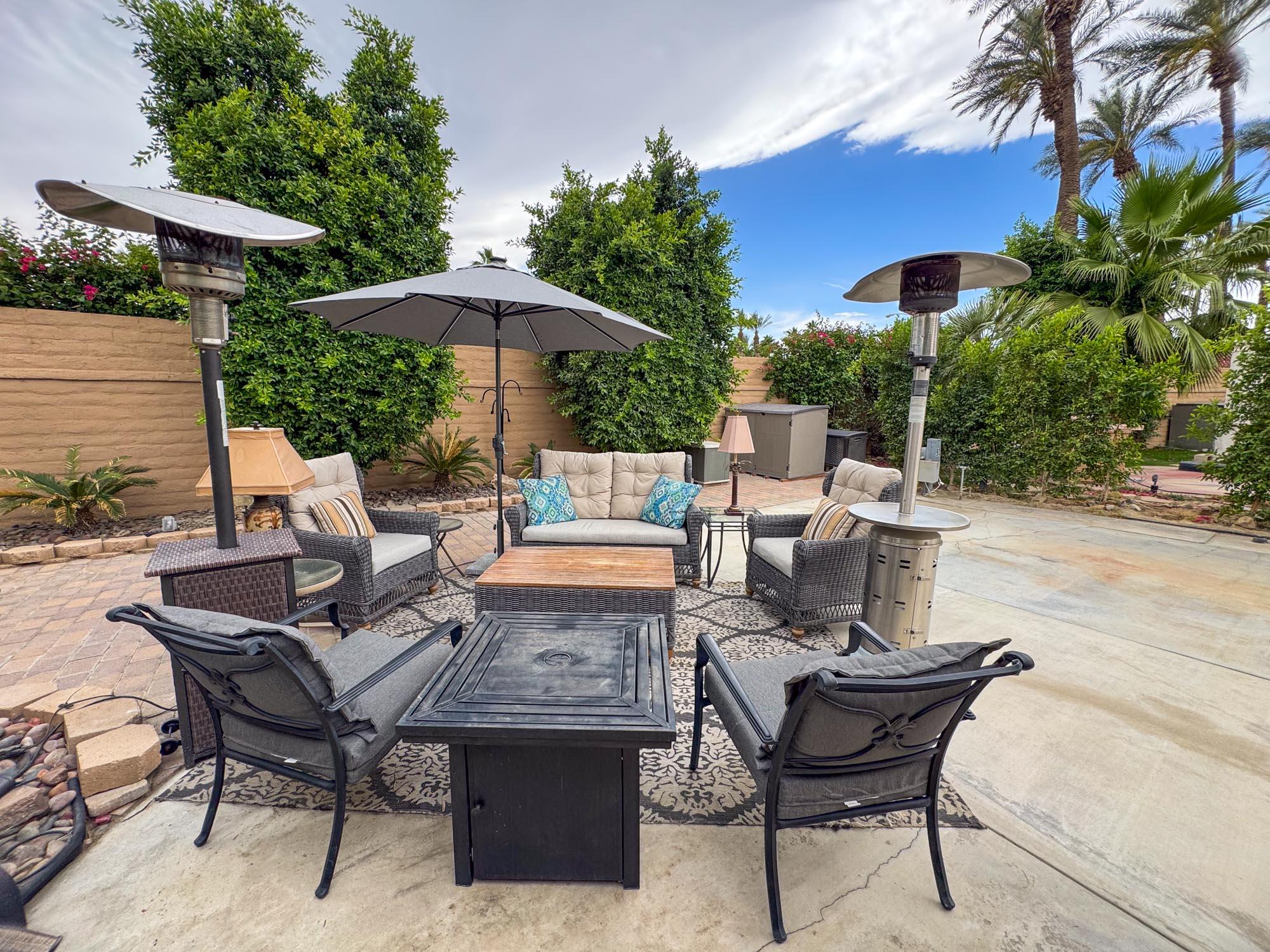 80394 Ave 48, Unit 90 Indio, CA 92201 - Photo 12 of 29 a view of an outdoor sitting area with furniture and umbrella