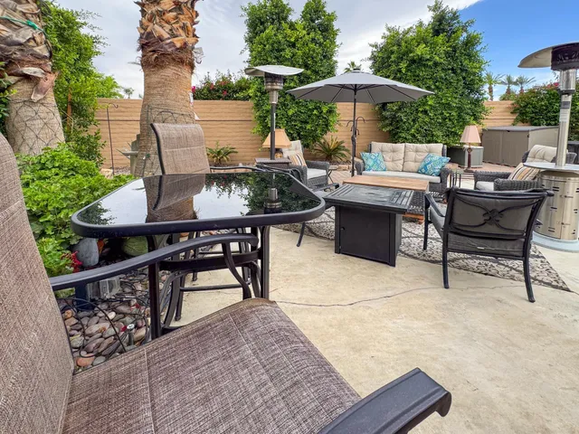 a view of a patio with a table and chairs