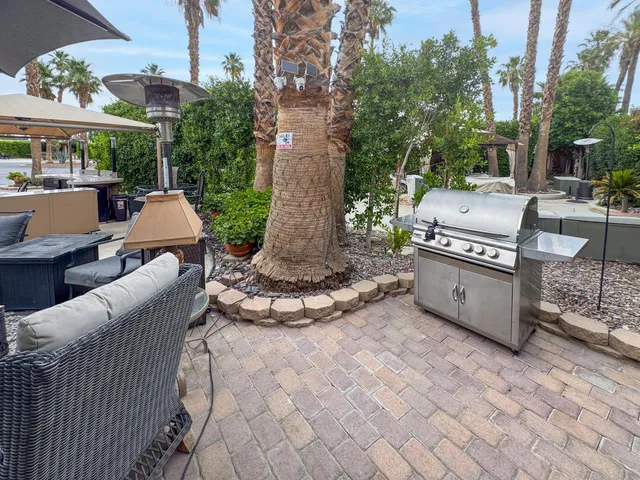 a view of a patio with a table and chairs