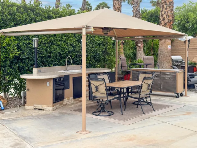 a view of a patio with a table chairs and a table