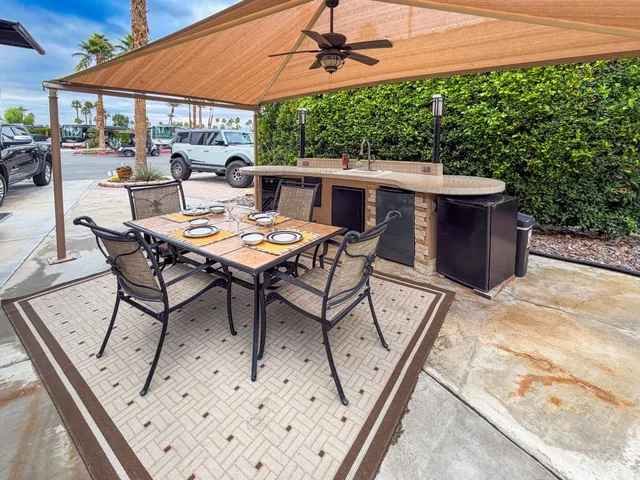 a patio with table and chairs