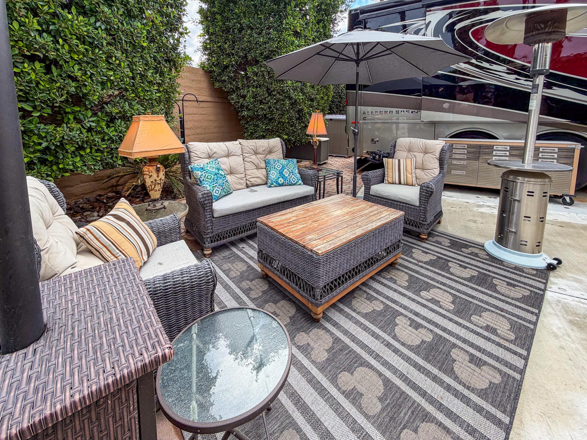 80394 Ave 48, Unit 90 Indio, CA 92201 - Photo 20 of 29 a patio with wooden floor a fire pit and outdoor seating