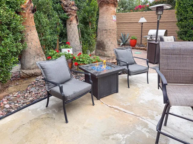a view of a chairs and table in backyard