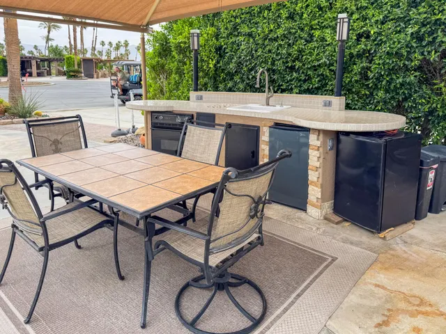 a view of a dinning table and chairs in the patio