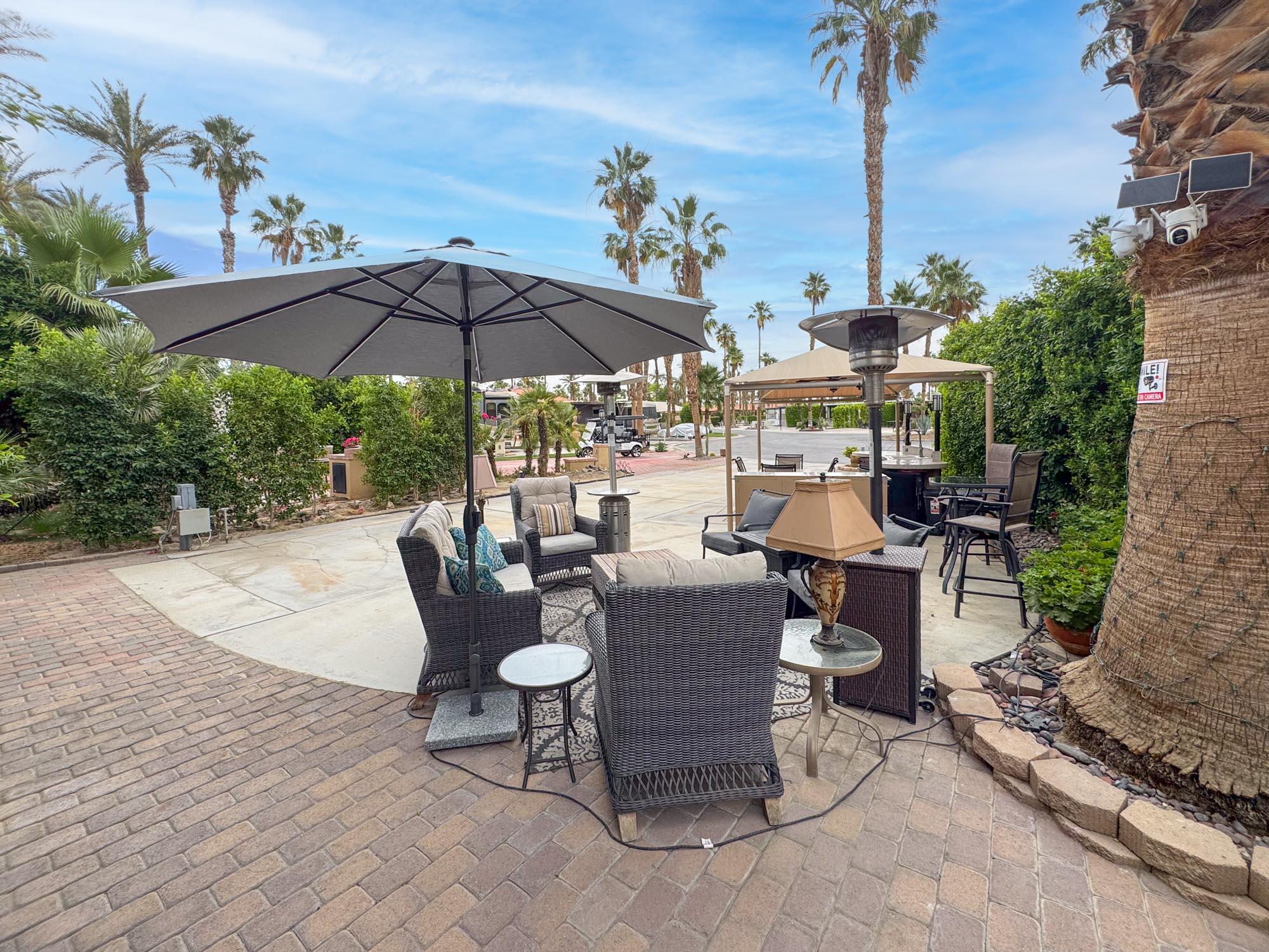 80394 Ave 48, Unit 90 Indio, CA 92201 - Photo 10 of 29 a view of a patio with chairs under an umbrella