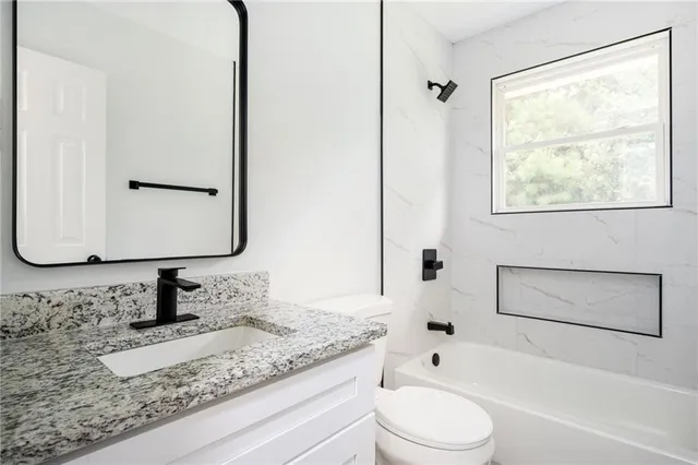 a view of a kitchen with a sink and a stove top oven
