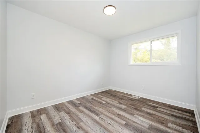 a bathroom with a granite countertop sink and a toilet