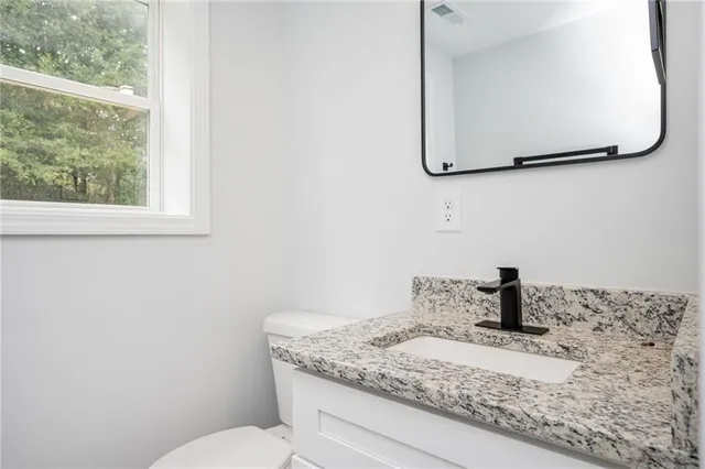 a bathroom with a toilet and a sink