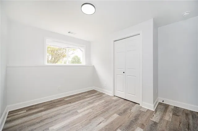a front view of house with yard and trees in the background