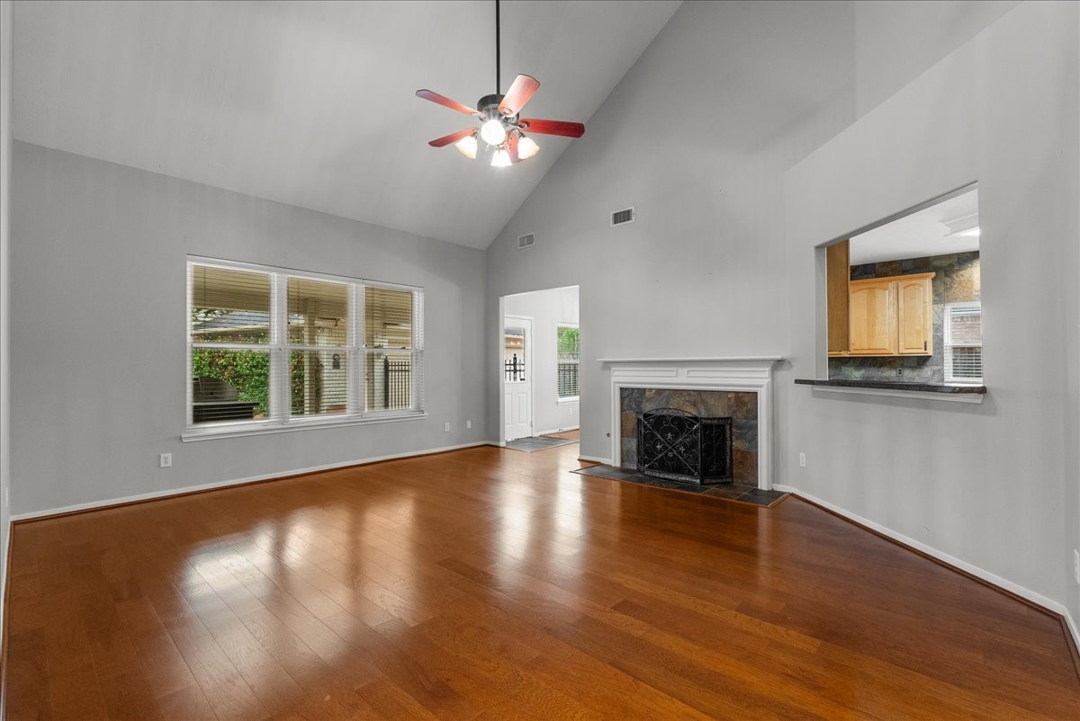 2876 Match Point Lane Friendswood, TX 77546 - Photo 15 of 45 Large family room with soaring ceilings and stone fireplace and windows overlooking the pool
