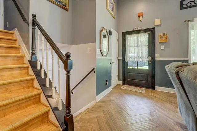 a view of a livingroom with wooden floor and stairs