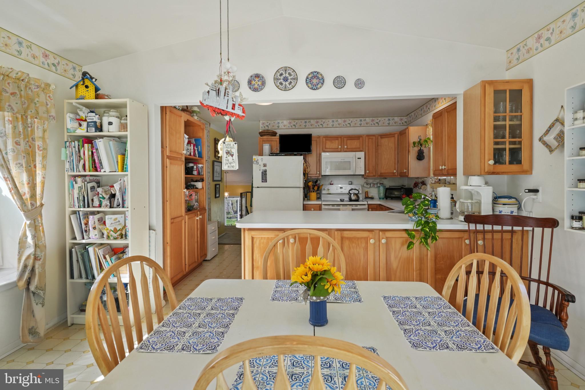 12733 Cunninghill Cove Road Middle River, MD 21220 - Photo 12 of 32 a dining room with furniture a rug and wooden floor