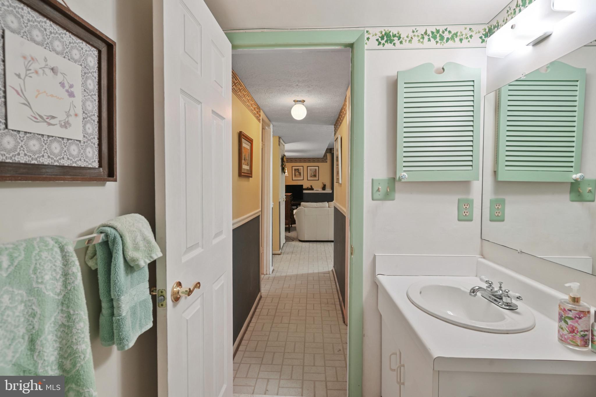 12733 Cunninghill Cove Road Middle River, MD 21220 - Photo 26 of 32 a bathroom with a sink a mirror and a shower