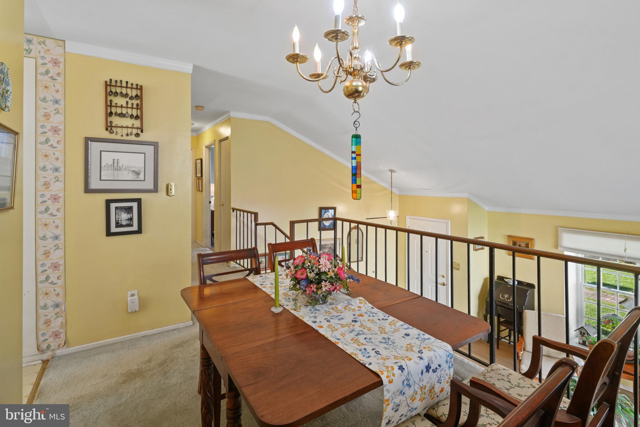 12733 Cunninghill Cove Road Middle River, MD 21220 - Photo 6 of 32 a view of a dining room with furniture wooden floor and chandelier
