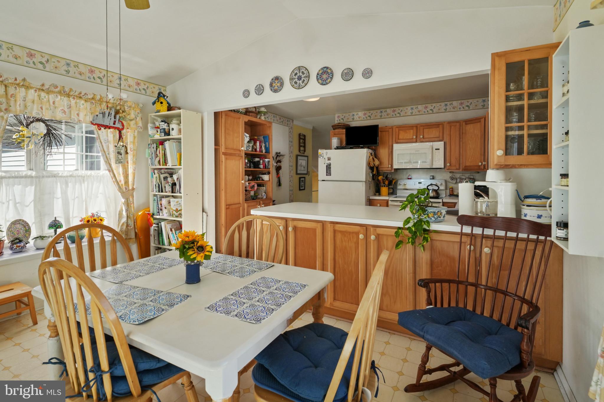 12733 Cunninghill Cove Road Middle River, MD 21220 - Photo 8 of 32 a view of a dining room and livingroom with furniture wooden floor a rug a painting and a chandelier