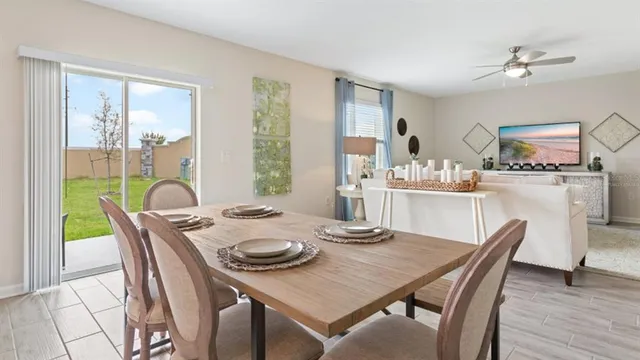 a dining room with furniture and wooden floor