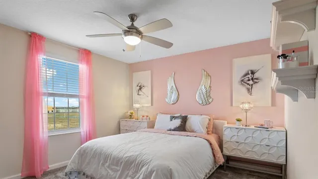 a bedroom with a large bed and a chandelier