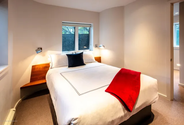 a bedroom with a bed and window