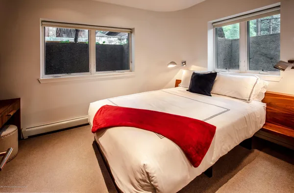 a bedroom with a bed and window