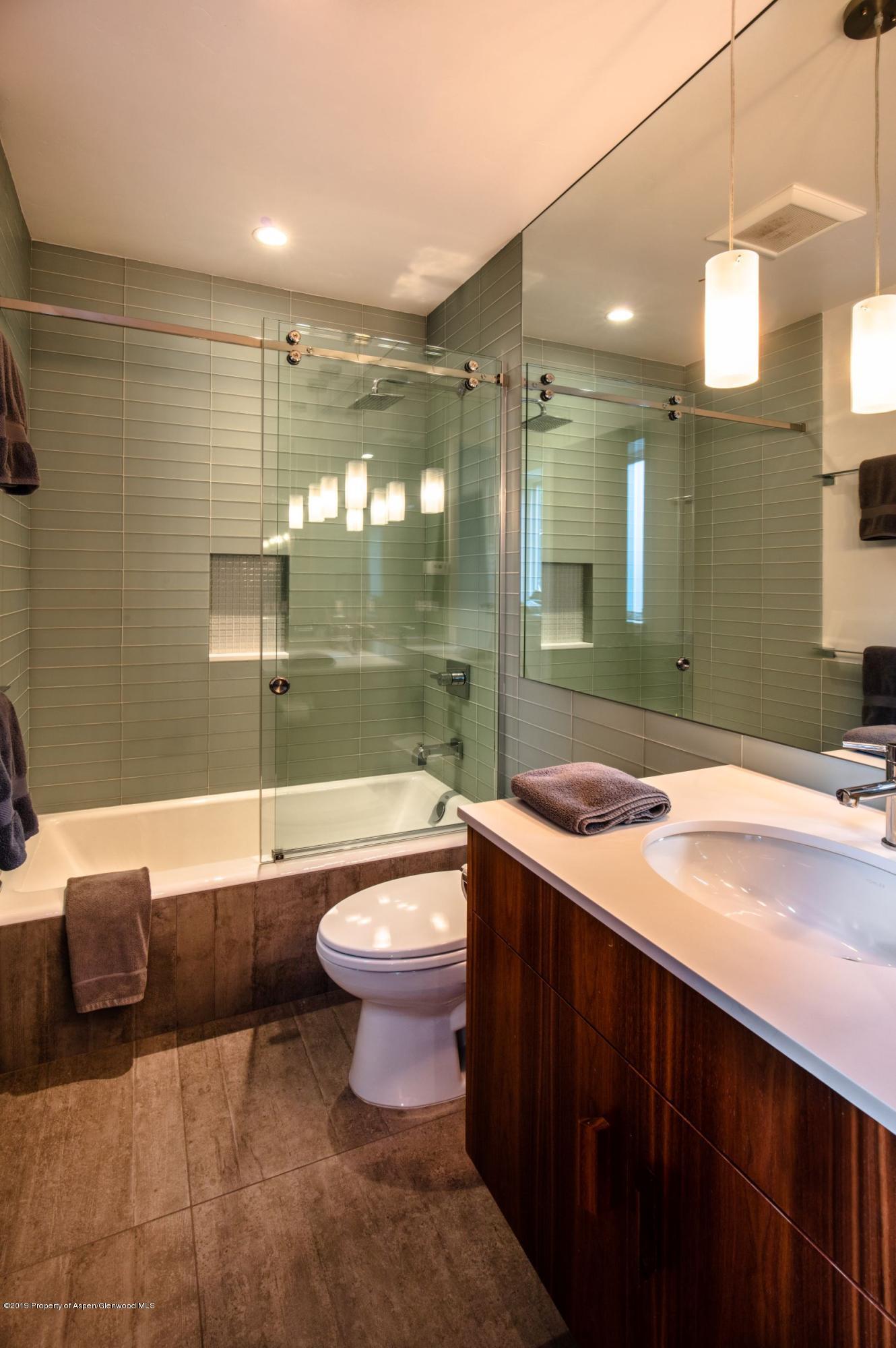 623 South Monarch Street, Unit : A Aspen, CO 81611 - Photo 20 of 22 a bathroom with a sink a toilet a mirror and bathtub