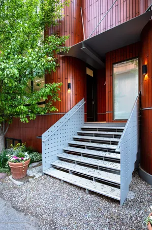 a view of a backyard with plants and a fire pit
