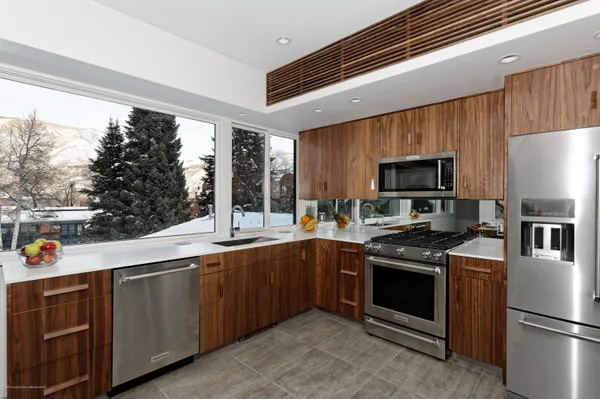 a kitchen with a sink appliances and cabinets