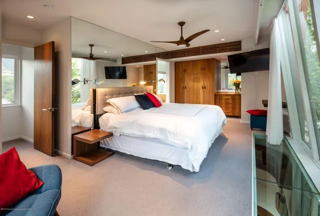 a bedroom with a bed couch and a window