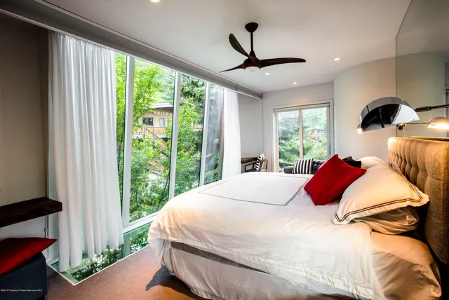 a bedroom with a bed and window