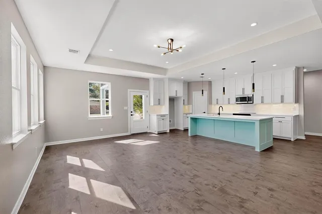 a view of kitchen with kitchen island and stainless steel appliances