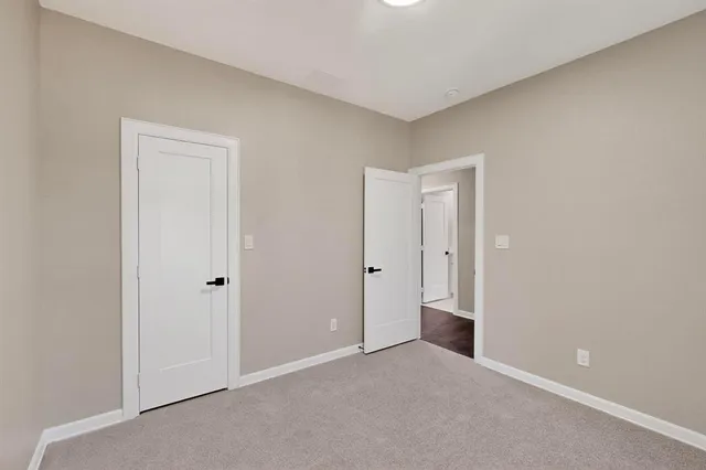 a view of an empty room and closet area