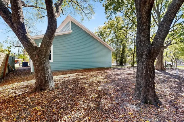 a view of a house with a tree in the yard