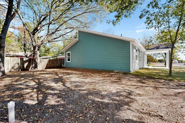 a view of a backyard with large trees
