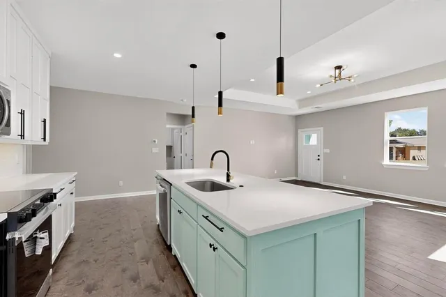 a kitchen with a sink and a stove top oven
