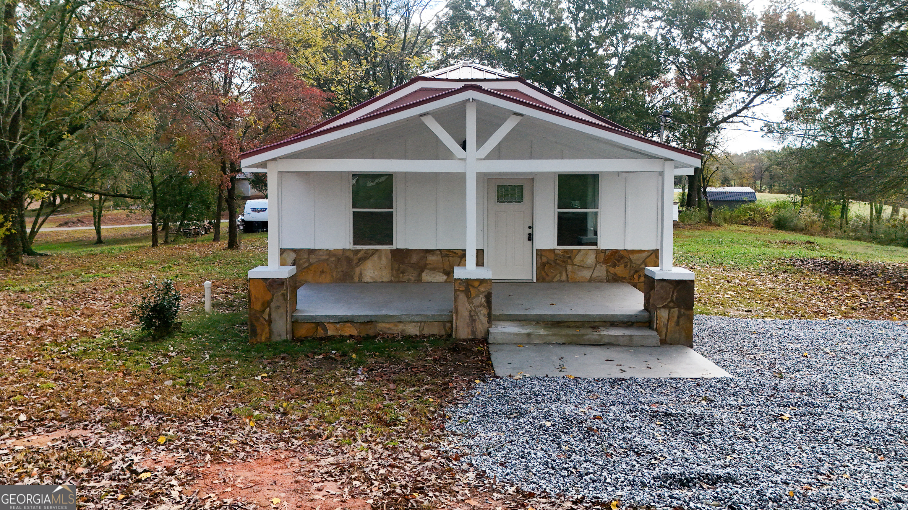 a front view of a house with a yard table and chairs