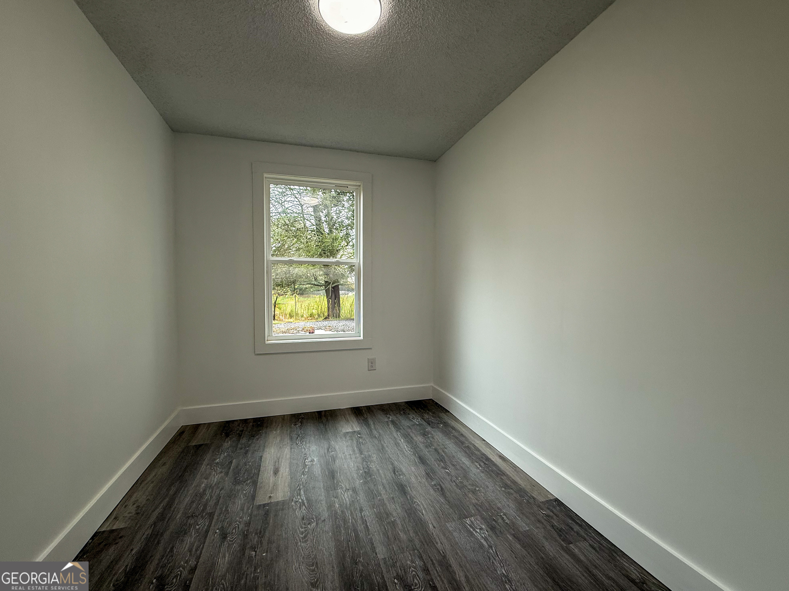 2301 Highway 254 Cleveland, GA 30528 - Photo 17 of 23 an empty room with wooden floor and windows
