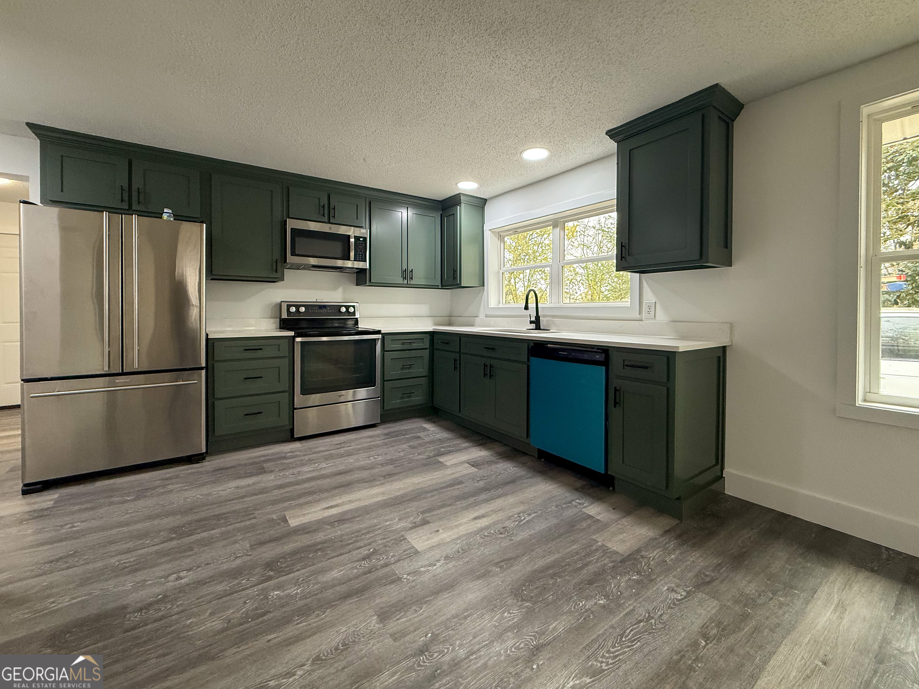 2301 Highway 254 Cleveland, GA 30528 - Photo 4 of 23 a kitchen with stainless steel appliances granite countertop a sink stove and refrigerator