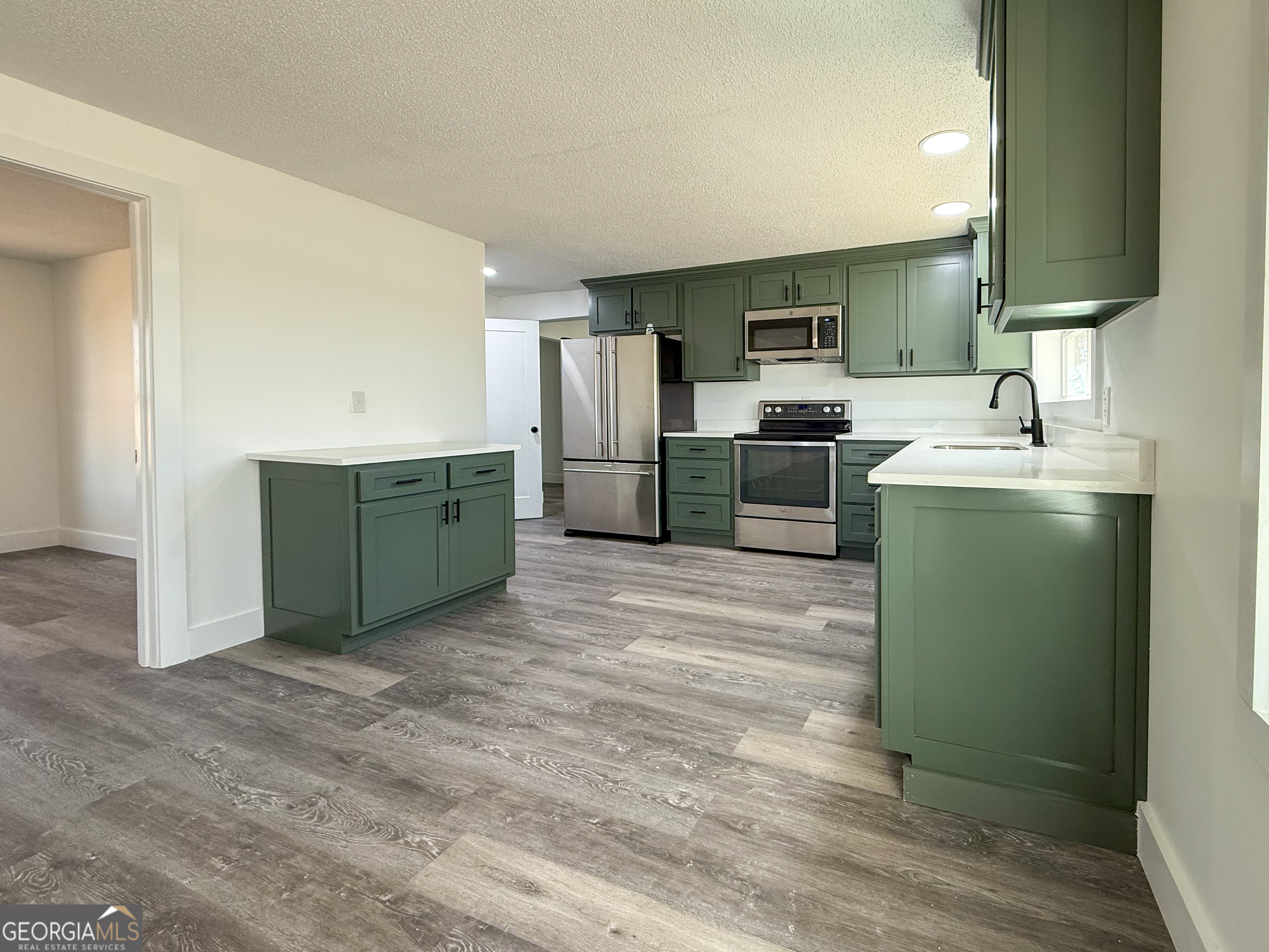 2301 Highway 254 Cleveland, GA 30528 - Photo 8 of 23 a kitchen with cabinets and stainless steel appliances