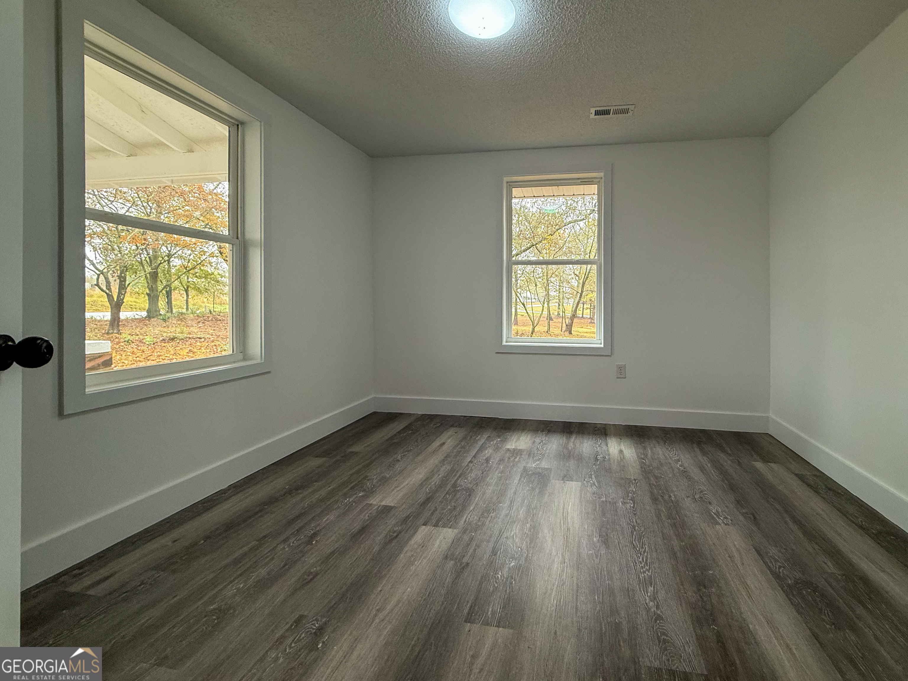 2301 Highway 254 Cleveland, GA 30528 - Photo 10 of 23 an empty room with wooden floor and windows