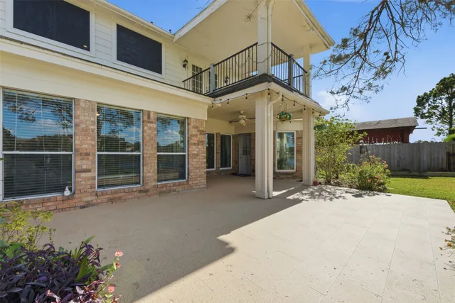 a front view of a house with a yard and outdoor seating