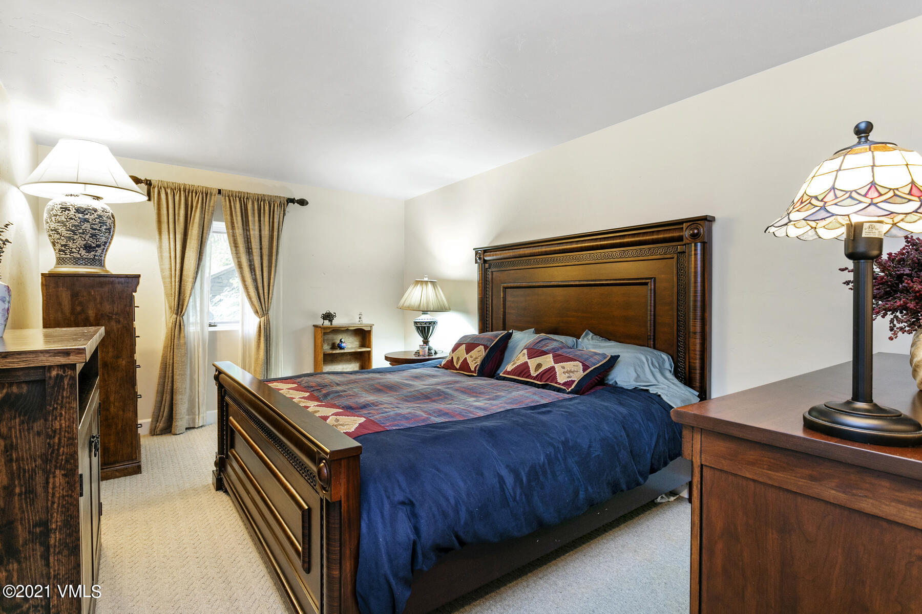 850 Eagle Drive Eagle-Vail, CO 81620 - Photo 31 of 44 a bedroom with a bed and a flat tv screen on the dresser