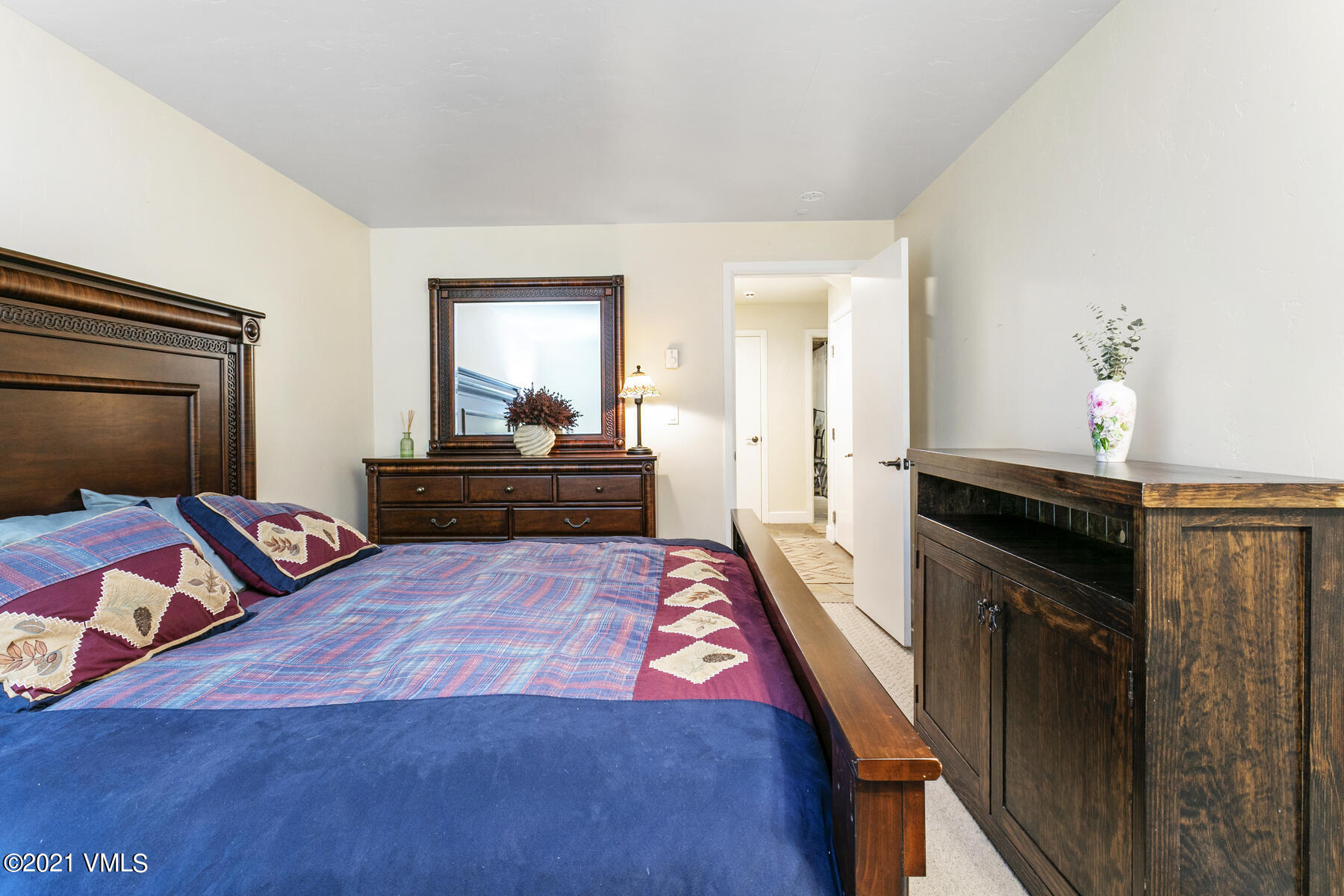 850 Eagle Drive Eagle-Vail, CO 81620 - Photo 32 of 44 a bedroom with a bed and a dresser in it